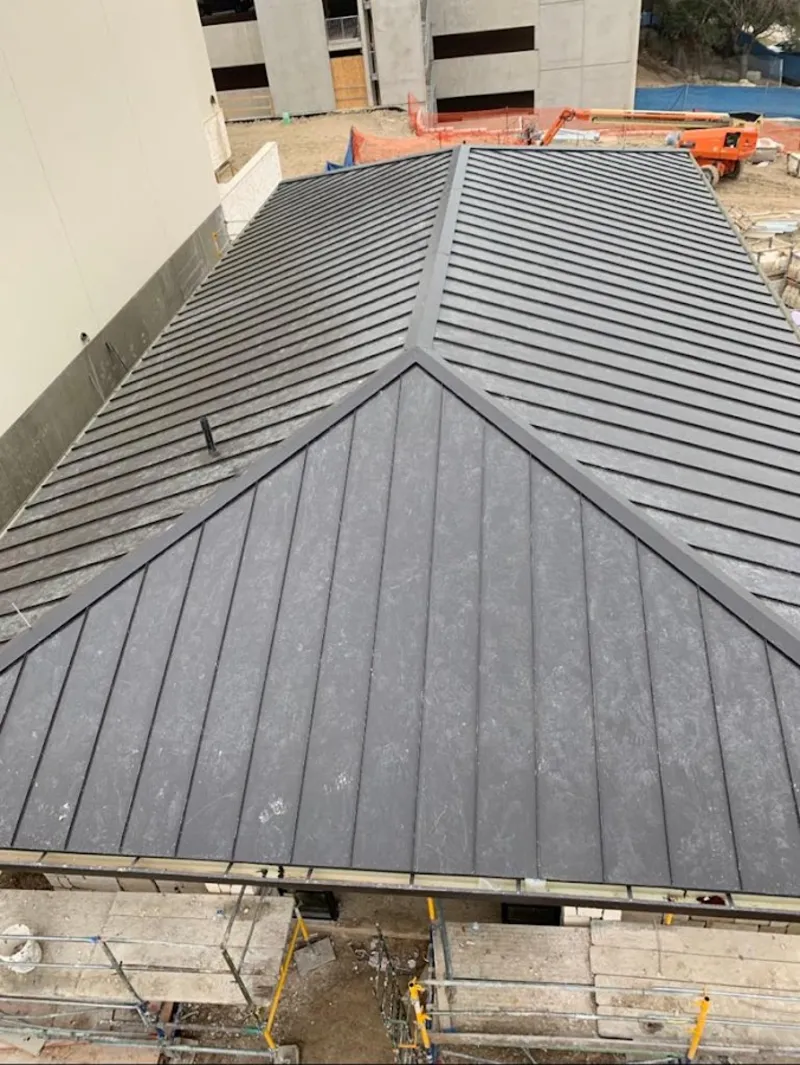 Commercial metal roof construction with crane equipment in Kannapolis